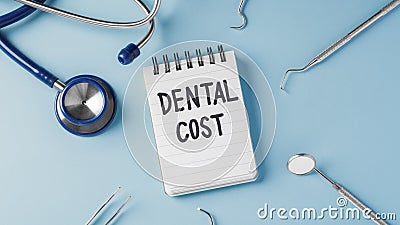 Dental treatment cost concept with dentist instruments on blue background Stock Photo