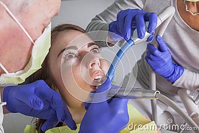 Dental treatment with drill and saliva sucker Stock Photo