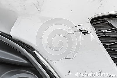 Dented wound and scratches on a damaged white car Stock Photo