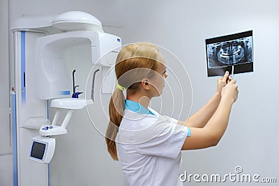 Dentist analyzes a dental panoramic x-ray film Stock Photo