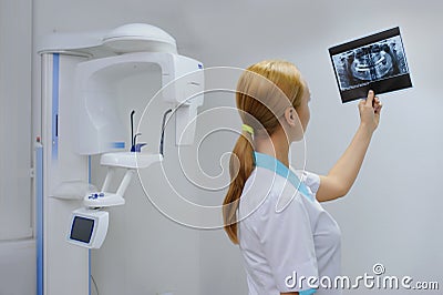 Dentist analyzes a dental panoramic x-ray film Stock Photo