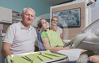 Dentist assistant and patient in the treatment room Stock Photo