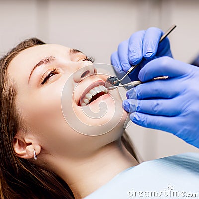 Dentist check-up teeth to young woman patient in clinic. Stock Photo