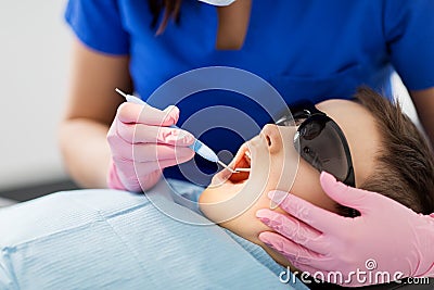 Dentist checking for kid teeth at dental clinic Stock Photo