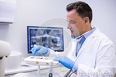 Dentist checking tools in dental clinic Stock Photo