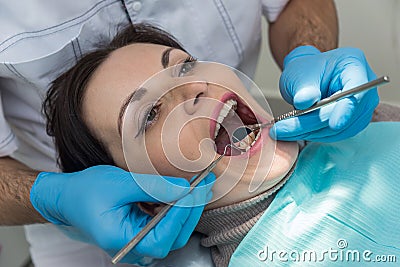 Dentist comparing patient`s teeth color with sampler Stock Photo