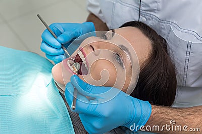 Dentist comparing patient`s teeth color with sampler Stock Photo