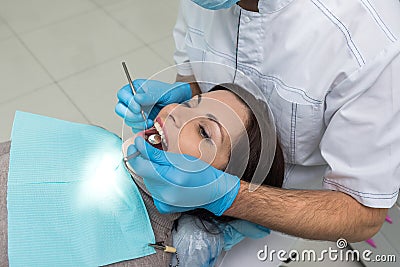 Dentist comparing patient`s teeth color with sampler Stock Photo