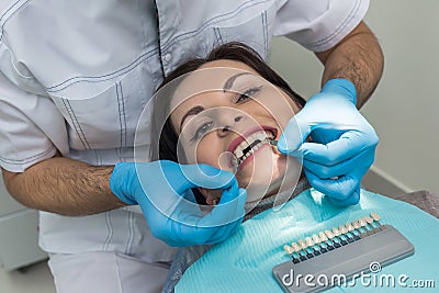 Dentist comparing patient teeth with crown sampler Stock Photo