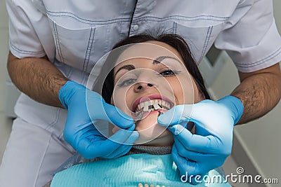 Dentist comparing patient teeth with crown sampler Stock Photo