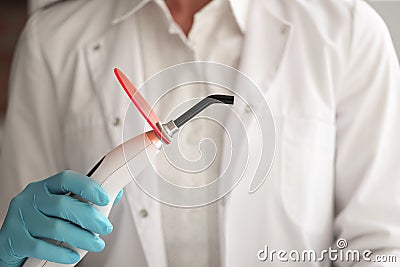 Dentist doctor holds curing light in hand Stock Photo