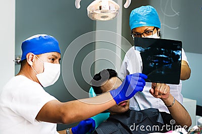 Dentist Doctor keeps in the hands of X-ray picture of the human jaw Stock Photo