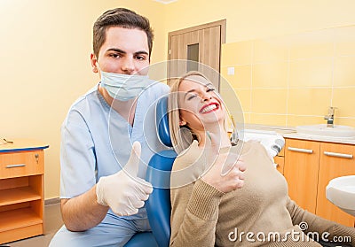 Dentist doctor and patient showing thumbs up Stock Photo