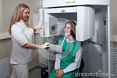Dentist doctor prepares the patient to take x-rays of the teeth. X-ray of teeth in a dental clinic. Modern dentistry. X-ray Stock Photo