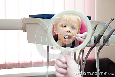 Dentist doing regular dental check-up to little boy. Stock Photo