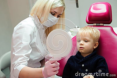Dentist doing regular dental check-up to little boy. Stock Photo