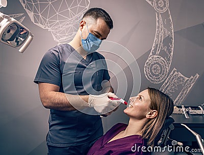 Dentist examine the colour of teeth Stock Photo