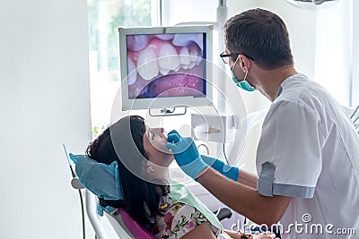 The dentist examines the patient with camera Stock Photo