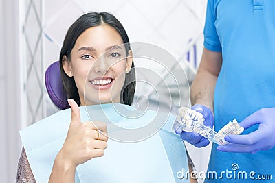 Dentist examines the patients teeth at the dentist. Stock Photo