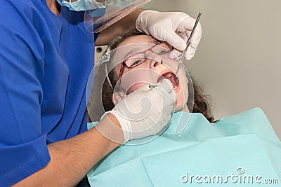 Dentist examining a girl teenager Stock Photo