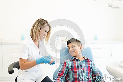 Dentist Explaining Patient At Clinic Stock Photo