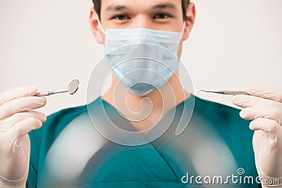 Dentist holding dental tools Stock Photo