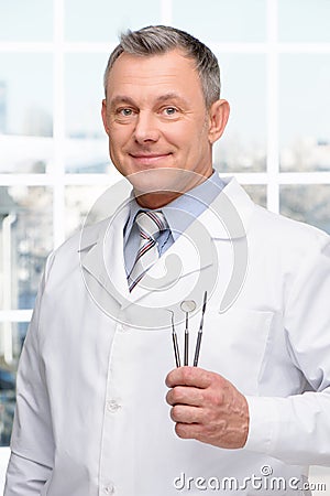 Dentist holding stomatologist tools Stock Photo