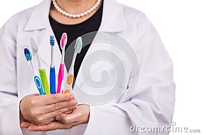 Dentist holding toothbrushes with different head and bristle design Stock Photo