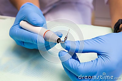 The dentist holds an ultrasonic scaler in his hands Stock Photo