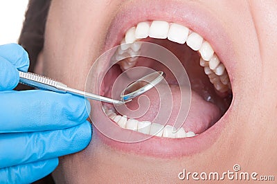 Dentist inspecting teeth using mirror Stock Photo