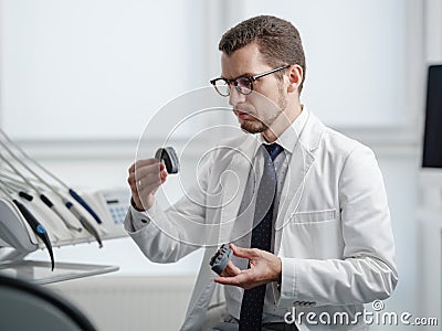 Dentist looking at photopolymer jaw printed on a 3d printer. Stock Photo