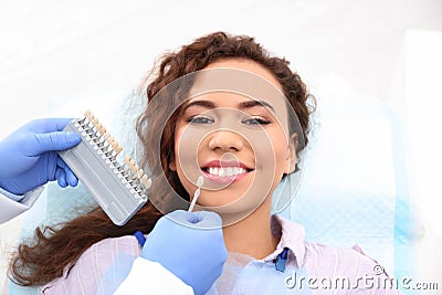 Dentist matching patient`s teeth color with palette Stock Photo