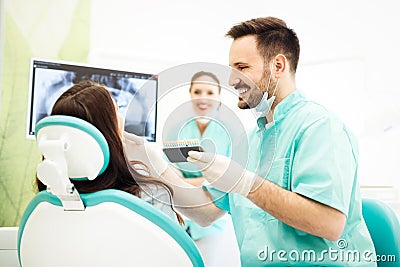 Dentist matching teeth color Stock Photo