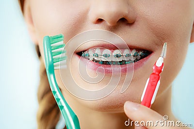 Girl with teeth braces using interdental and traditional brush Stock Photo