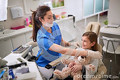 Dentist prepares patient for tooth repair Stock Photo