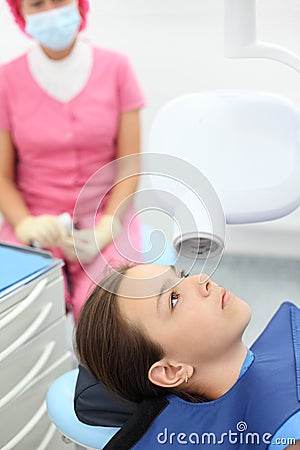 Dentist prepares to make jaw x-ray image for girl Stock Photo