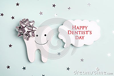 Dentist`s Day greeting card with tooth and speech bubble on a blue Stock Photo