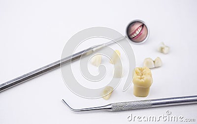 Dentist's tools, tooth model teeth and girl's smile in a mirror Stock Photo