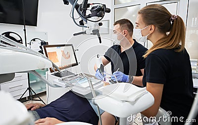 Dentist scanning patient's teeth with modern machine for intraoral scanning. Stock Photo
