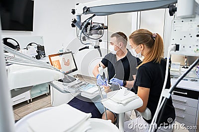 Dentist scanning patient& x27;s teeth with modern machine for intraoral scanning. Stock Photo
