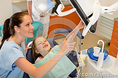 Dentist showing child dental procedure on monitor Stock Photo