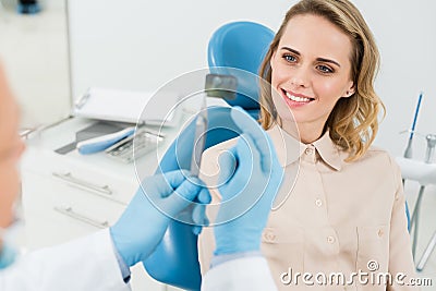 Dentist showing female patient x-ray in modern Stock Photo