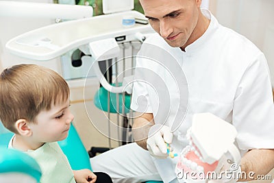 Dentist showing how to brush teeth and use toothbrush Stock Photo