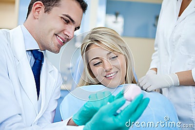 Dentist showing teeth sample Stock Photo