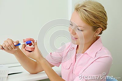 Dentist shows how to correctly brush teeth Stock Photo