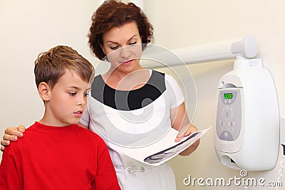 Dentist shows jaw x-ray image for boy Stock Photo