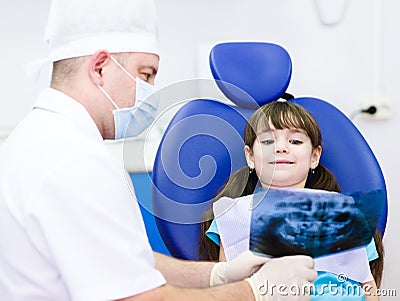 Dentist shows a patient x-ray of teeth Stock Photo