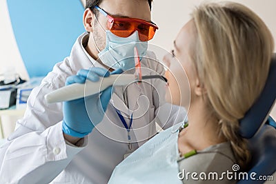 Dentist taking care of patient tooth Stock Photo