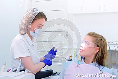 Dentist talks with woman patient on preventive examination stomatology clinic. Stock Photo