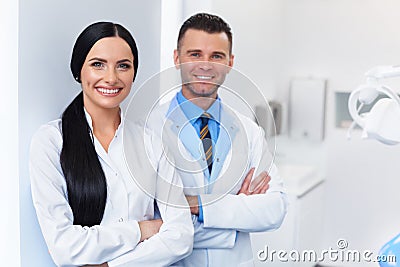 Dentist Team at Dental Clinic. Two Smiling Doctors at their Work Stock Photo